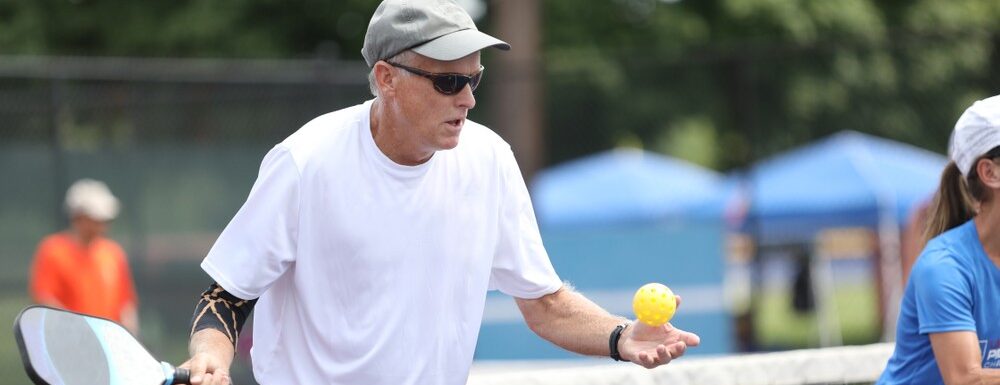 Seniors playing pickleball in the park